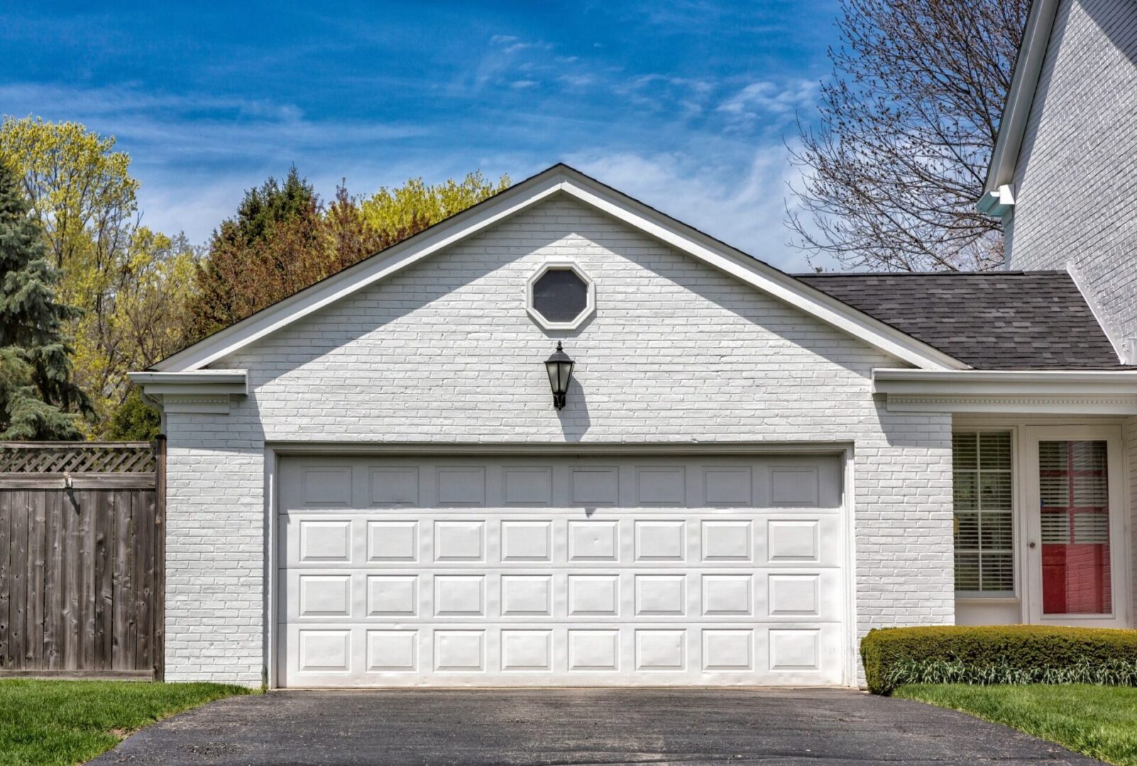 A white garage with two doors and a large window.