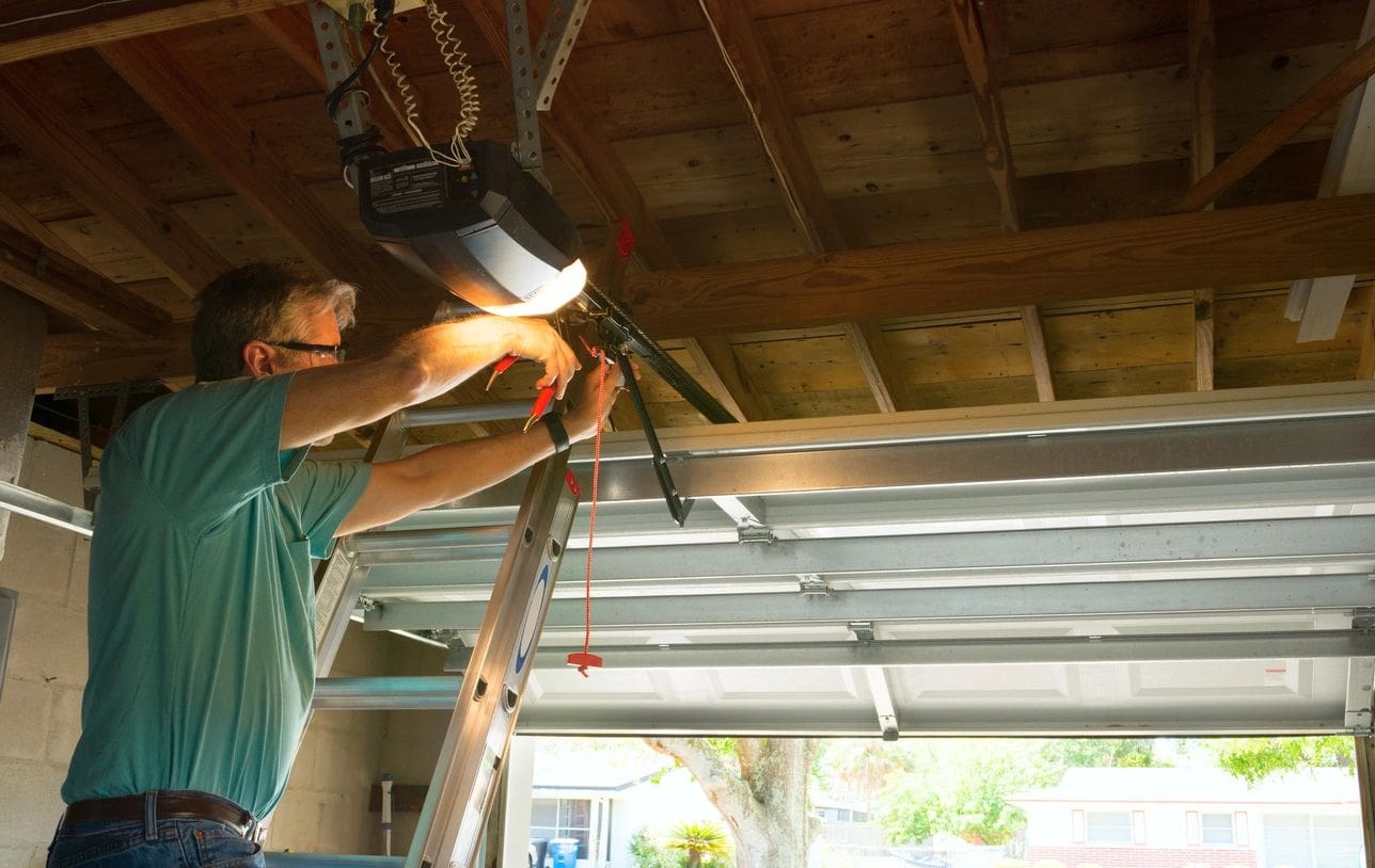 A man working on the garage door.